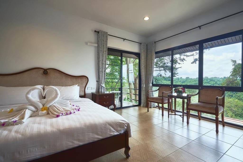 Retreat bedroom with floor-to-ceiling jungle view